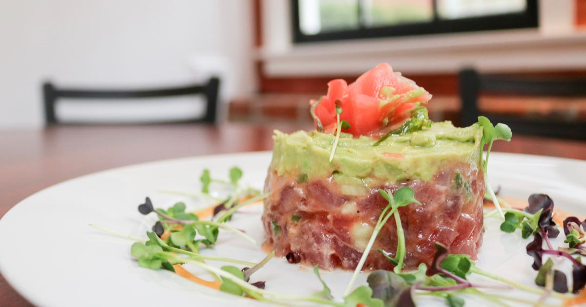 Tuna tartare on plate with microgreens